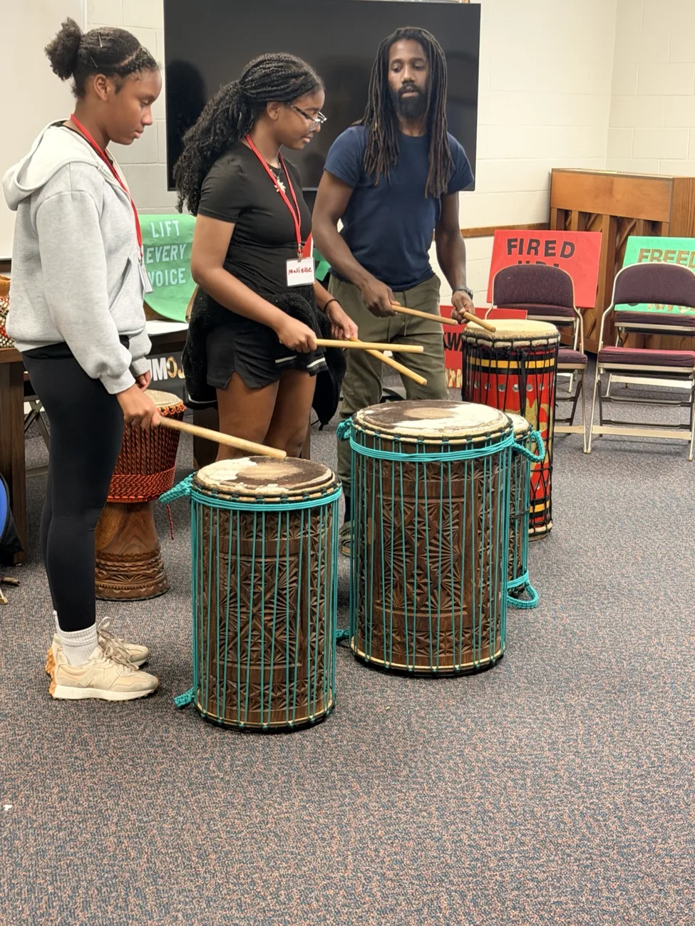 Students playing drums together