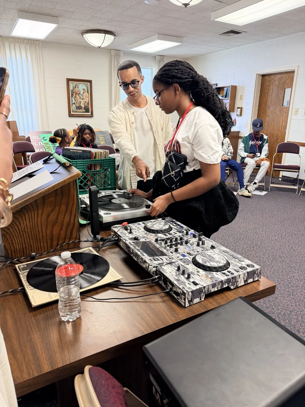 Students practicing with DJ equipment