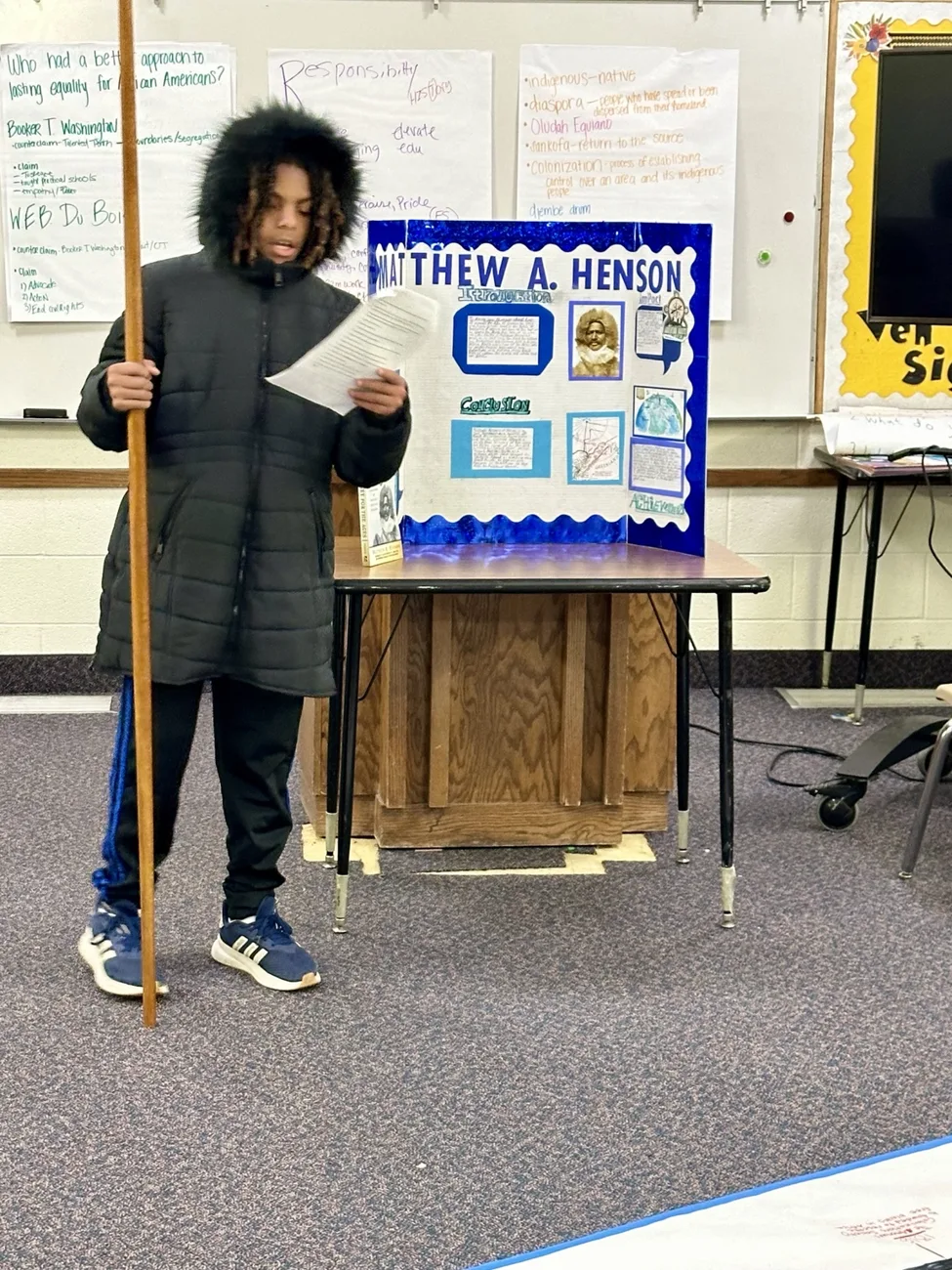 A student presenting a research poster