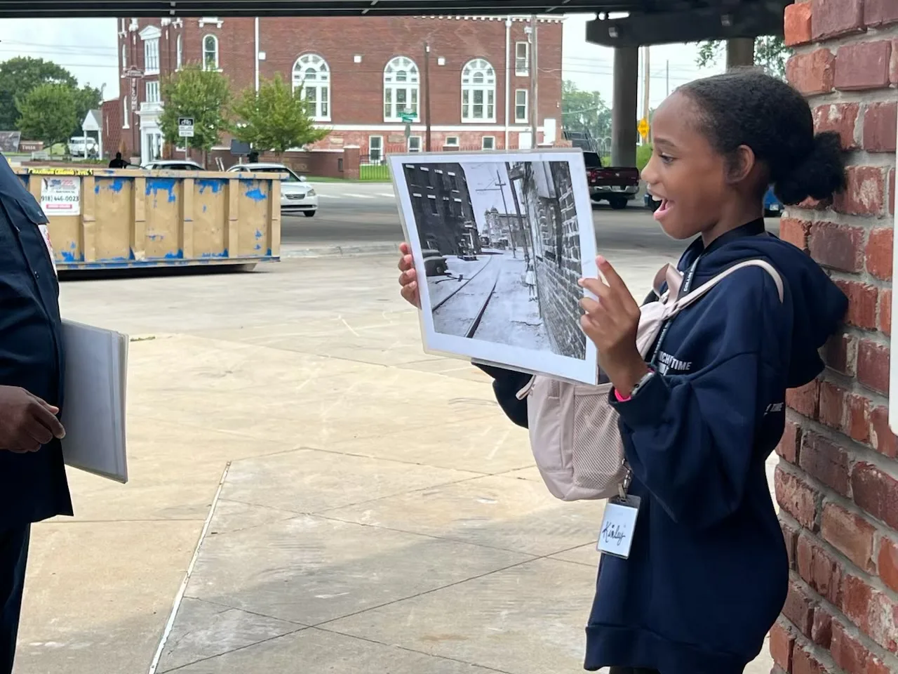 A speaker sharing historical photographs during a field experience