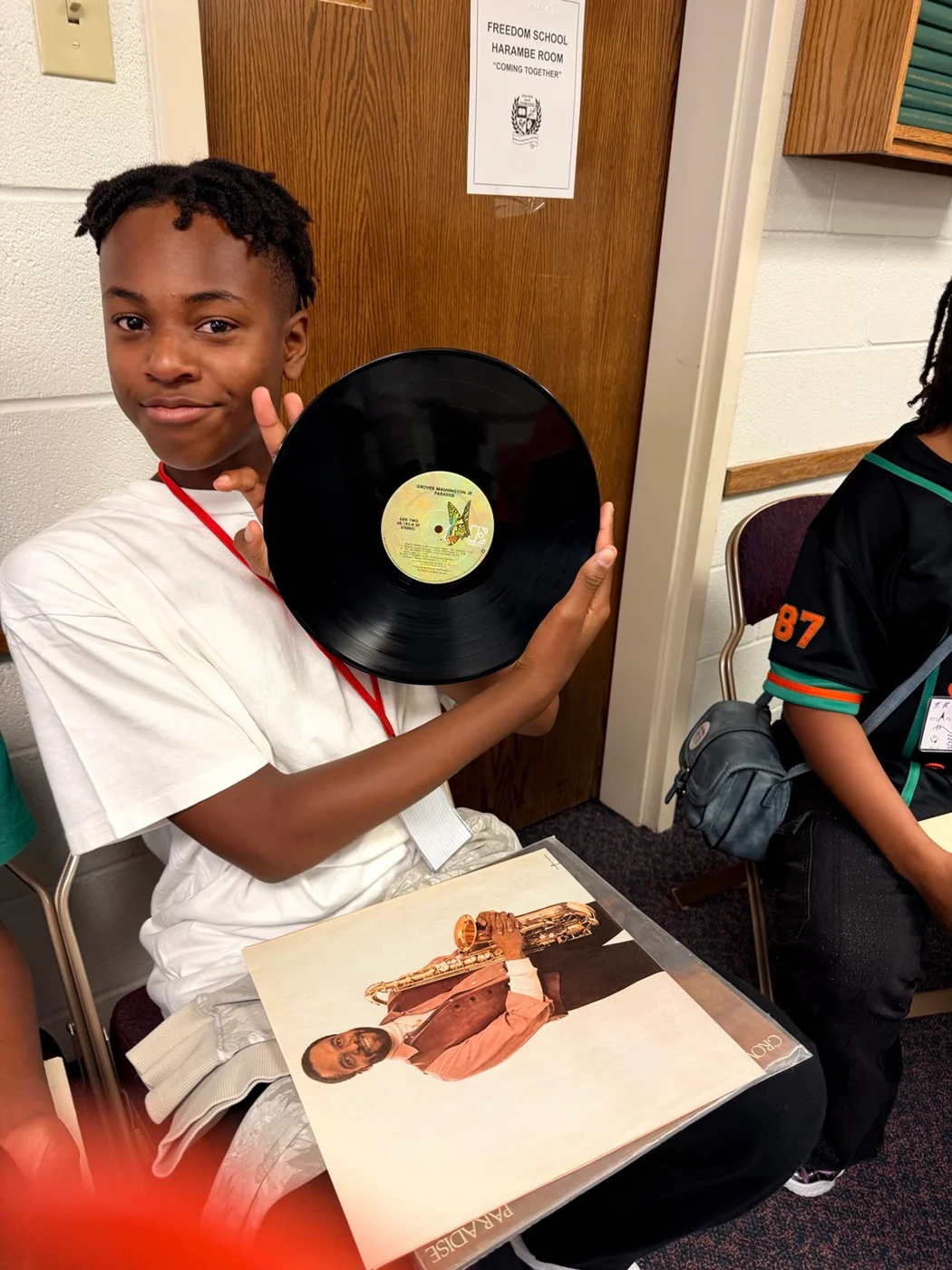 A Freedom School scholar holding a vinyl record